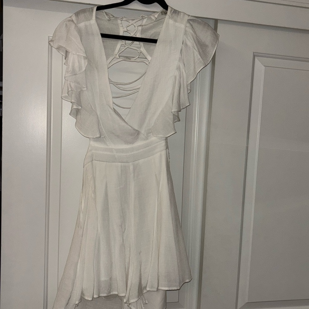 White women’s romper with open cross back design